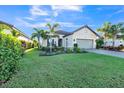 Landscaped home exterior with paver driveway and lush lawn at 12826 Sorrento Way, Bradenton, FL 34211