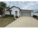 White house with gray garage door and small front yard at 13262 Jeter Creek Dr, Riverview, FL 33579