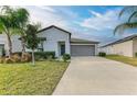 Modern one-story house with driveway and landscaping at 13262 Jeter Creek Dr, Riverview, FL 33579