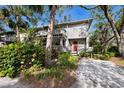 Gray two-story townhome with lush landscaping and a paver walkway at 1479 Landings Cir # 41, Sarasota, FL 34231