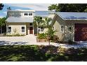 Modern farmhouse style home with metal roof and spacious driveway at 1608 80Th Nw St, Bradenton, FL 34209