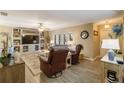 Living room with comfy seating, a large TV, and wood-look floors at 2146 Como St, Port Charlotte, FL 33948