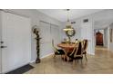 Small dining area with round table and four unique chairs at 2416 Amherst Ave, Bradenton, FL 34207