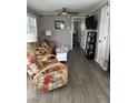 Living room with comfy seating and gray vinyl flooring at 2601 Gulf N Dr # 528, Bradenton Beach, FL 34217