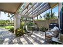 Covered patio with seating area and wooden pergola at 3105 Sandleheath # 1, Sarasota, FL 34235