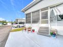 Steps leading to the entrance of a mobile home with potted plants at 3333 26Th E Ave # 1155, Bradenton, FL 34208