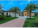 Stunning curb appeal with palm trees and brick driveway at 3354 Founders Club Dr, Sarasota, FL 34240