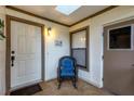 Inviting front porch with rocking chair, white door, and window at 365 Oak Hill Way # 32, Sarasota, FL 34232