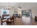 Bright living room with hardwood floors, and sliding glass doors leading to patio at 365 Oak Hill Way # 32, Sarasota, FL 34232