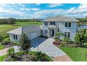 Luxury home with tile roof and a three-car garage at 3761 Founders Club Dr, Sarasota, FL 34240