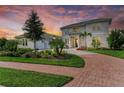 Two-story home with brick paver driveway and landscaped yard at 3761 Founders Club Dr, Sarasota, FL 34240