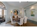 Elegant dining room with a large table, neutral decor, and natural light at 4452 Mcintosh Lake Ave, Sarasota, FL 34233