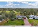 House nestled on a spacious lot with lush greenery at 5006 W Country Club Dr, Sarasota, FL 34243