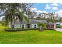 Charming single story home with manicured lawn at 5006 W Country Club Dr, Sarasota, FL 34243