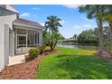 Screened patio overlooking a canal with lush landscaping at 6234 Sturbridge Ct, Sarasota, FL 34238