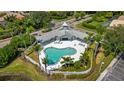 Community pool with a clubhouse and surrounding landscaping at 6234 Sturbridge Ct, Sarasota, FL 34238