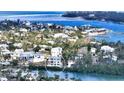 Aerial view of a house on the waterfront, near other homes at 625 Jackson Way, Longboat Key, FL 34228