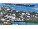 Aerial view of a house on the waterfront, near other homes at 625 Jackson Way, Longboat Key, FL 34228