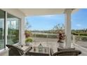 Relaxing balcony with water views and wicker furniture at 625 Jackson Way, Longboat Key, FL 34228