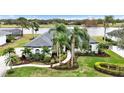 One-story house with gray roof, landscaping, and walkway; view of lake at 7117 River Club Blvd, Bradenton, FL 34202