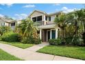 Two-story townhome with screened balcony and green door at 7417 Vista Way # 106, Bradenton, FL 34202