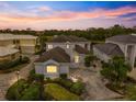 Luxury home with a tile roof and a meticulously landscaped yard at 7716 Club Ln, Sarasota, FL 34238