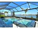 Resort-style pool and spa with covered lanai overlooking lake at 8052 Grande Shores Dr, Sarasota, FL 34240