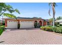 Brick driveway and three-car garage at 8628 Woodbriar Dr, Sarasota, FL 34238