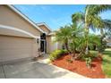 Home's front entrance, featuring a screened door and landscaping at 8752 Monterey Bay Loop, Bradenton, FL 34212