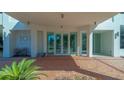 Condominium building entrance with modern design and brick walkway at 101 S Gulfstream Ave # 8G, Sarasota, FL 34236