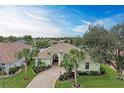 Stunning curb appeal of a single-Gathering home with a circular driveway at 115 Grand Oak Cir, Venice, FL 34292