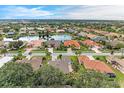 Community overview showcasing a serene lake and numerous homes at 120 Grand Oak Cir, Venice, FL 34292