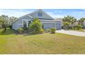 Two-story house with a landscaped yard and paved driveway at 12556 Ryegrass Loop, Parrish, FL 34219