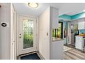 Bright entryway with glass door and view of kitchen at 1701 Pelican Cove Rd # 359, Sarasota, FL 34231
