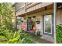 Cozy patio with seating and tropical plants at 1701 Pelican Cove Rd # 359, Sarasota, FL 34231