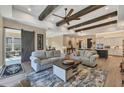Spacious living room with hardwood floors, exposed beams, and comfortable seating at 18096 Home Run Dr, Venice, FL 34293