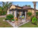 Relaxing patio area with pergola, seating, and beautiful landscaping at 20255 Macon Ln, Port Charlotte, FL 33952