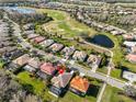 Aerial view of a neighborhood with golf course, ponds and mature trees at 219 Heritage Isles Way, Bradenton, FL 34212