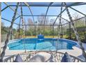 A tranquil screened pool with a decorative water feature and comfortable lounge seating at 219 Heritage Isles Way, Bradenton, FL 34212