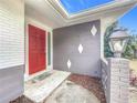 Charming front entrance with red door and unique design at 2523 Darwin Ave, Sarasota, FL 34239