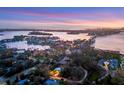 Aerial view of waterfront property and surrounding neighborhood at 3414 Old Oak Dr, Sarasota, FL 34239