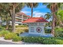 Sunbow Bay entrance sign with landscaping and building view at 3801 E Bay Dr # 209, Holmes Beach, FL 34217