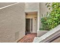 Private condo entry with brick walkway and lush greenery at 5128 Marsh Field Ln # 129, Sarasota, FL 34235
