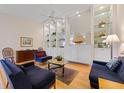 Bright living room features built-in shelving, comfortable seating, and hardwood floors at 5839 Helicon Pl, Sarasota, FL 34238