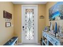 Bright entryway with decorative glass door and beach-themed decor at 6065 Worsham Ln # 104, Bradenton, FL 34211