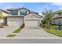 Two-story home with two-car garage and a well-maintained front yard at 6065 Worsham Ln # 104, Bradenton, FL 34211