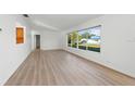 Spacious living room featuring hardwood floors and an abundance of natural light at 6116 Rodgers Ave, Sarasota, FL 34231