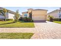 Single-story home with tile roof, driveway, and landscaped lawn at 6247 Champions Row St, Bradenton, FL 34210