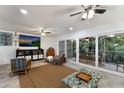 Open living area with sliding doors, large TV, and two comfy armchairs at 6250 Holmes Blvd # 71, Holmes Beach, FL 34217