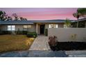 Evening view of condo with walkway and landscaping at 6884 W Country Club Ln, Sarasota, FL 34243